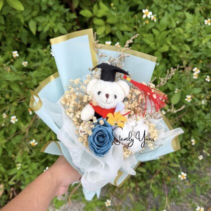 Graduation bouquet with teddy bear, blue rose, and baby’s breath by Stemly Yours.